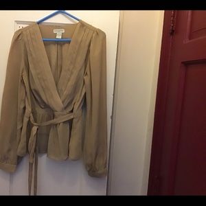 Beige blouse front half way.  With a front belt.  Made in China.  100% Polyester